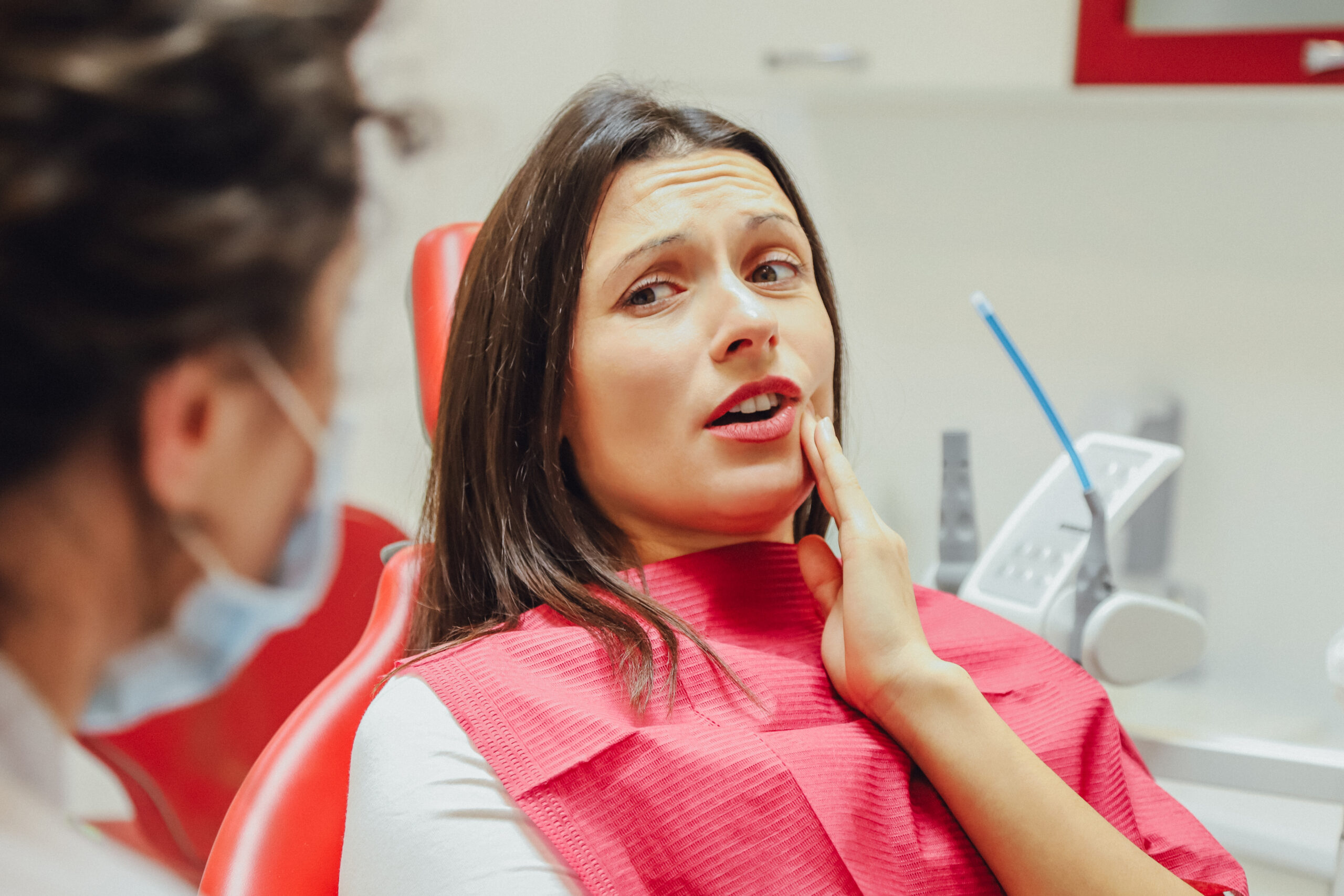 Patient experiencing tooth pain during an emergency dental visit at Rittenhouse Dentists